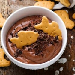 Overhead image of Edible Brownie Batter in a white bowl with cookies