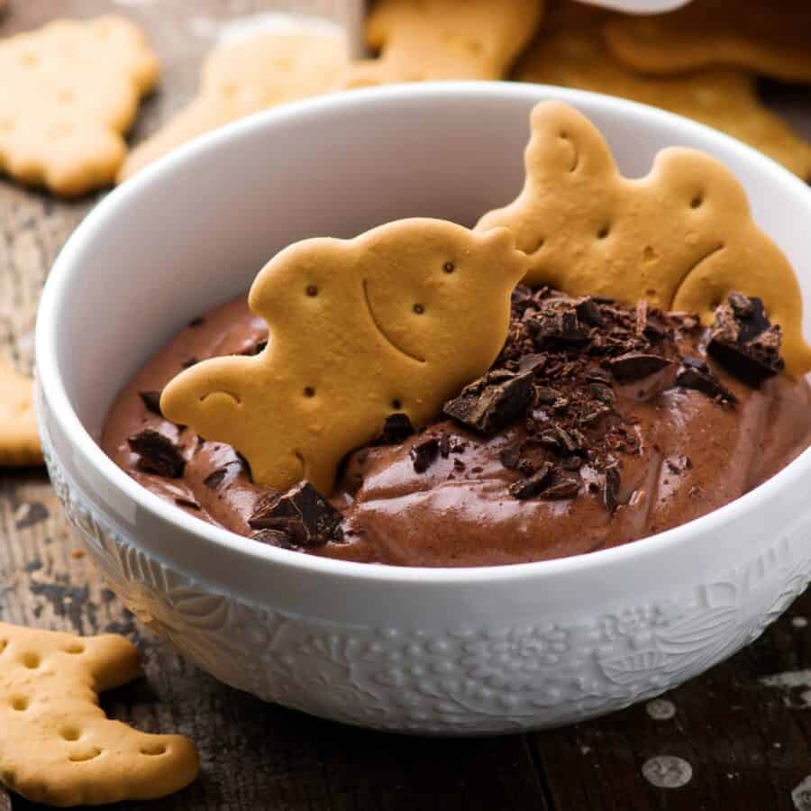 Close up image of Edible Brownie Batter in a white bowl with cookies