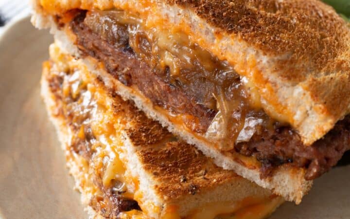 A Patty Melt Sandwich on a plate with salad on the side