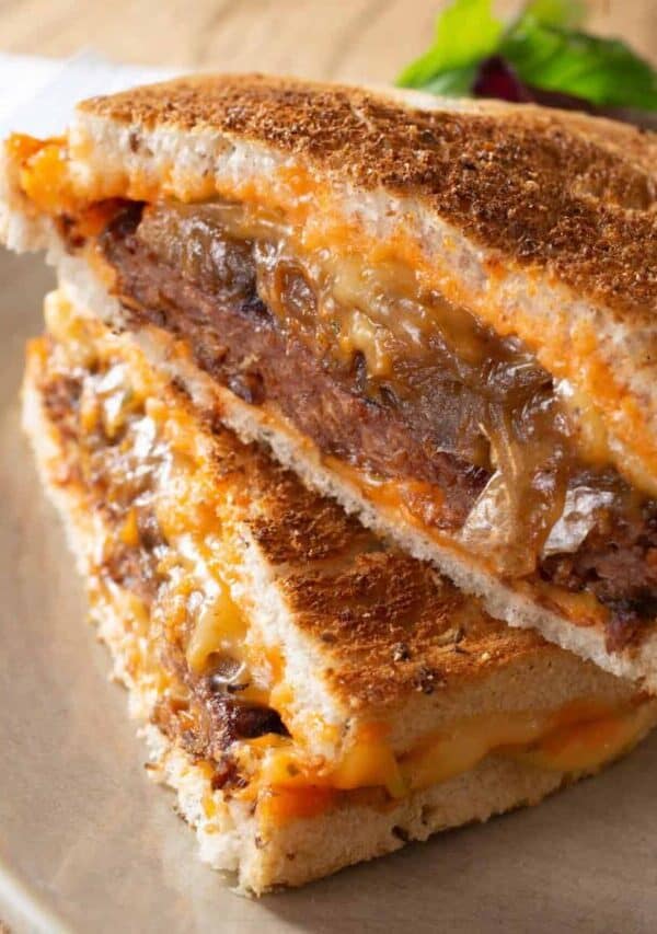 A Patty Melt Sandwich on a plate with salad on the side