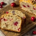 Cranberry Cake on a wooden cutting board with slices - 8