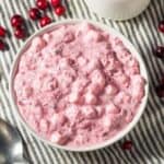 Overhead image of Cranberry Fluff in a white bowl with cranberries scattered around it - 8