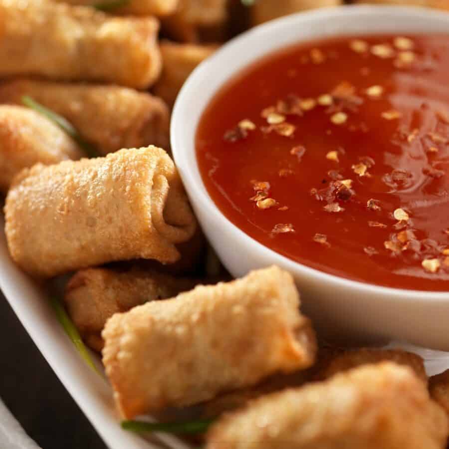 Egg Roll Dipping sauce in a white bowl next to mini egg rolls
