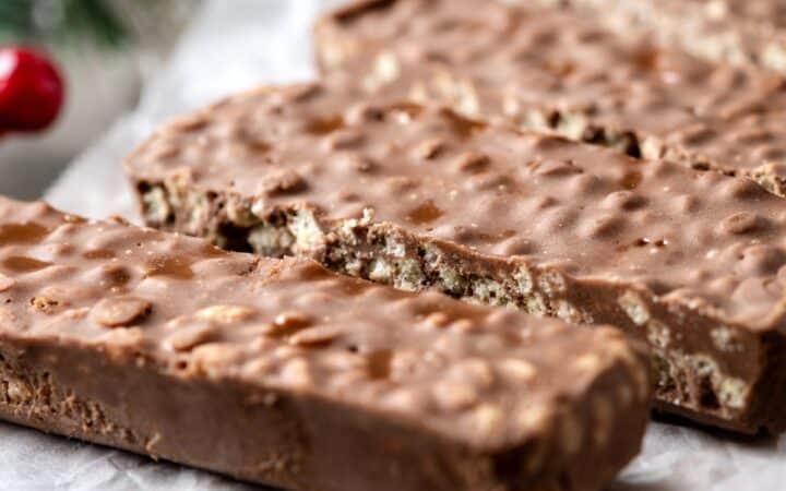 Homemade Crunch Bars on a rustic table with parchment paper
