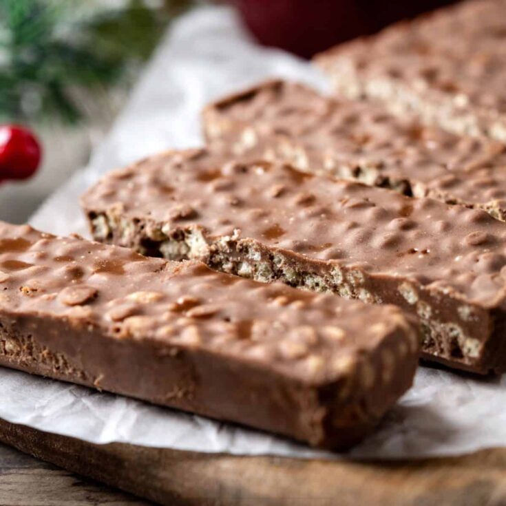 Homemade Crunch Bars on a rustic table with parchment paper