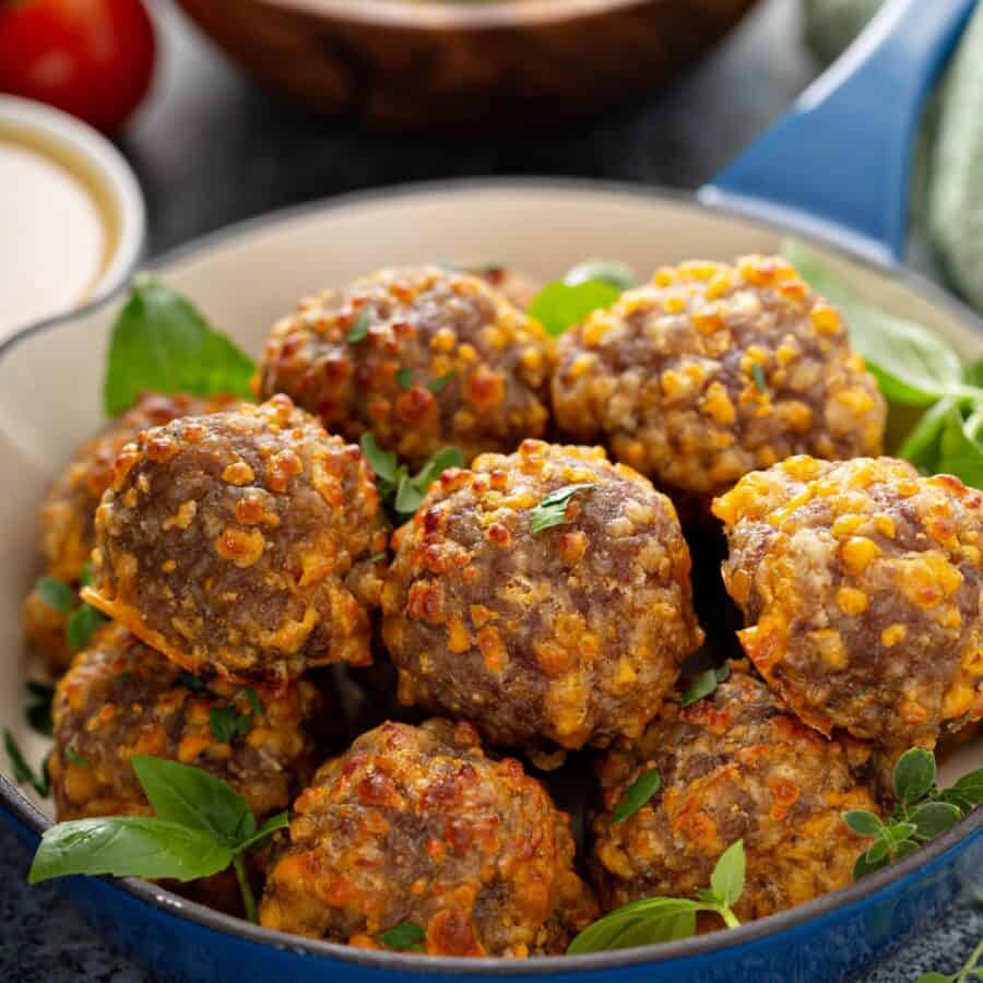 Overhead image of air fryer sausage balls in a blue bowl