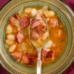 Overhead image of slow cooker ham and beans in a bowl with a spoon - 8
