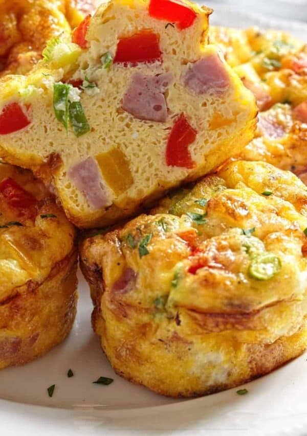 Frittata Muffins on a white plate with one cut in half