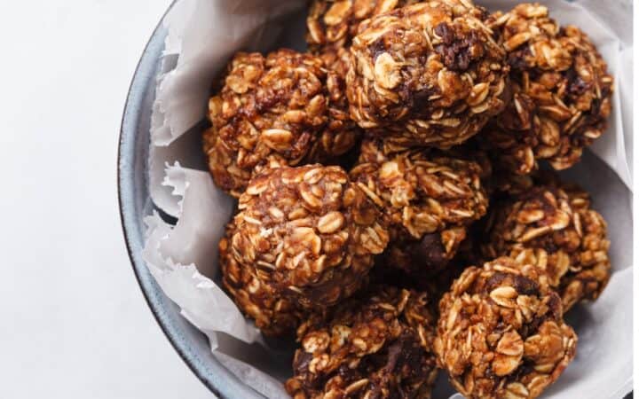 Overhead image of chocolate balls in a bowl with parchment paper