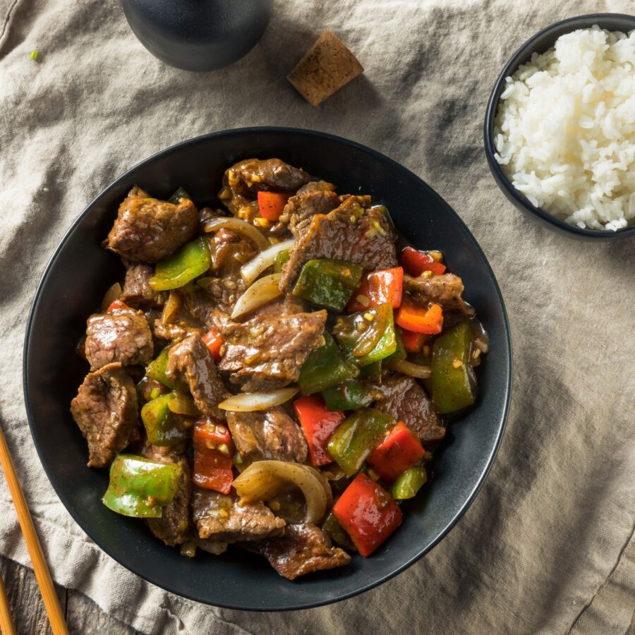 Overhead image of Pepper Steak in a bowl with rice on the side