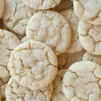 A close up image of a bunch of soft sugar cookies stacked on top of eachother