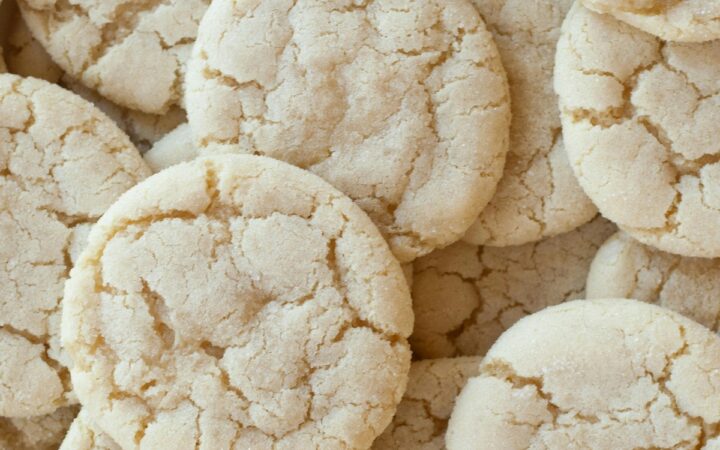 A close up image of a bunch of soft sugar cookies stacked on top of eachother
