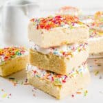 Sugar Cookie Bars stacked on top of eachother on a bright white surface - 8