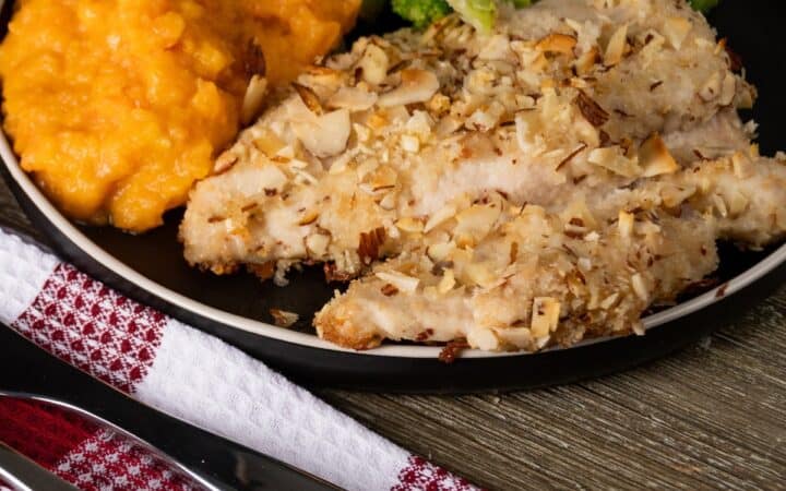Almond Crusted Chicken on a plate with side dishes - 5