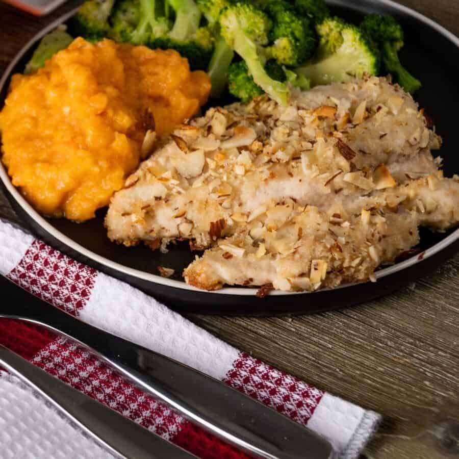 Almond Crusted Chicken on a plate with side dishes - 2