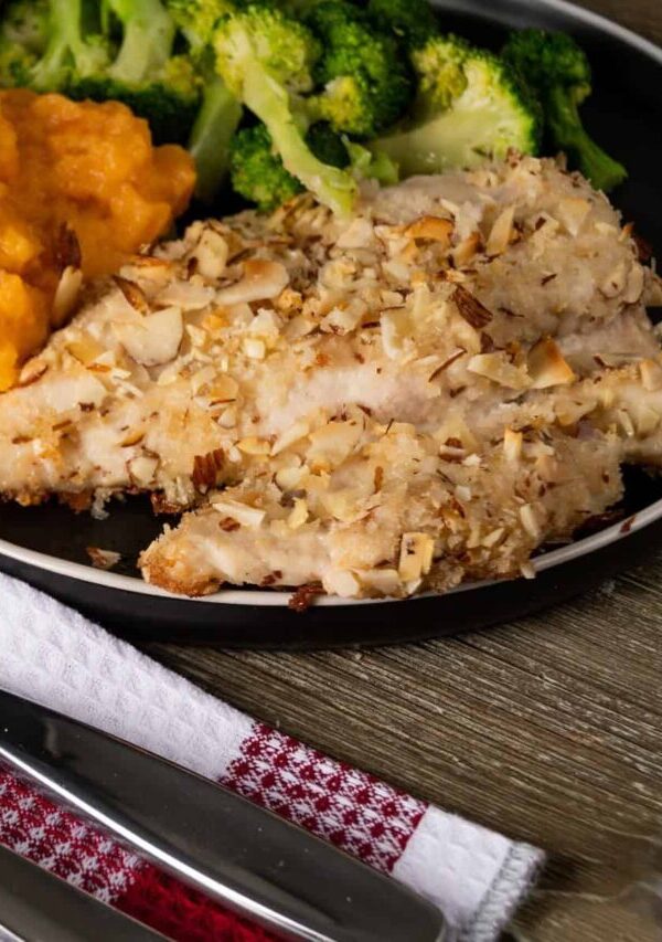 Almond Crusted Chicken on a plate with side dishes