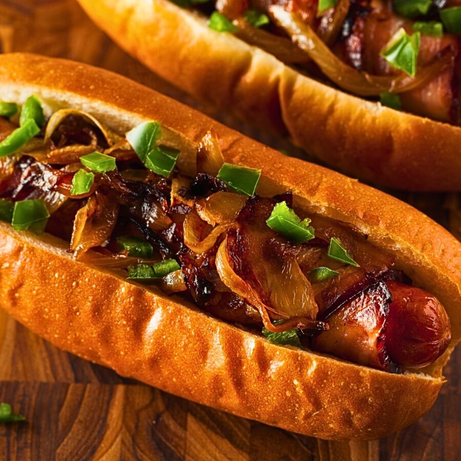 overhead imge of two bacon wrapped hot dogs in buns