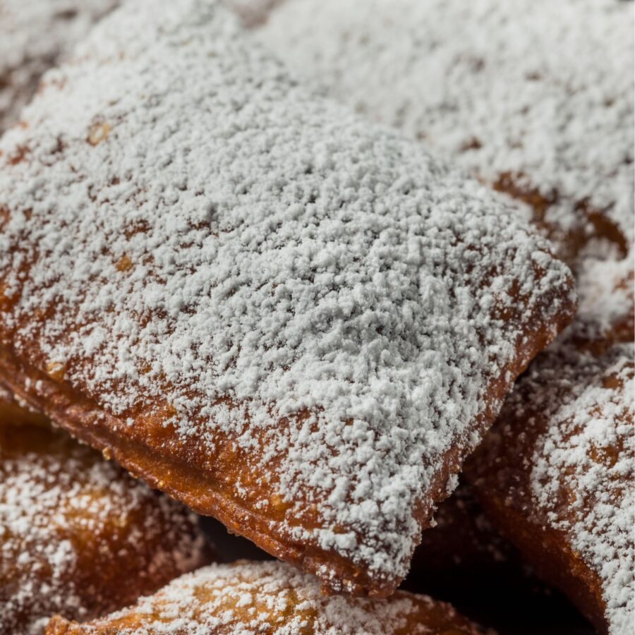 Close up image of beignets stacked on a plate