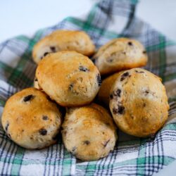 Blueberry Biscuits on a plaid cloth stacked in a pile