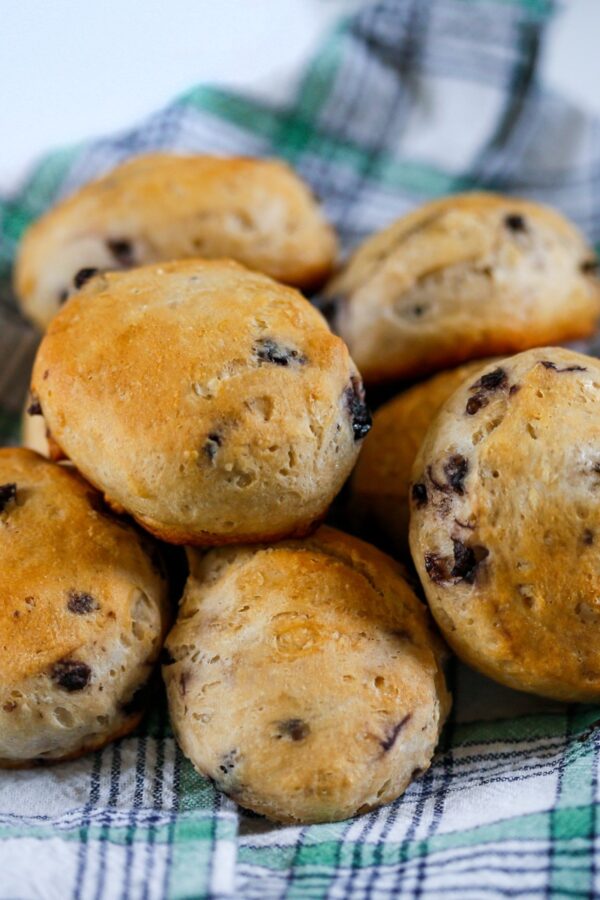 Blueberry Biscuits on a plaid cloth stacked in a pile