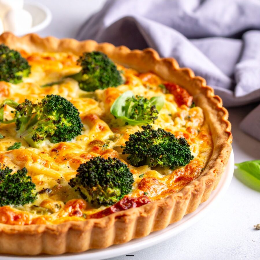 Close up image of a broccoli quiche on a white plate - 25