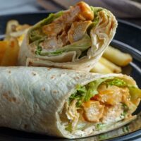 Close up image of a Buffalo Chicken Wrap cut in half