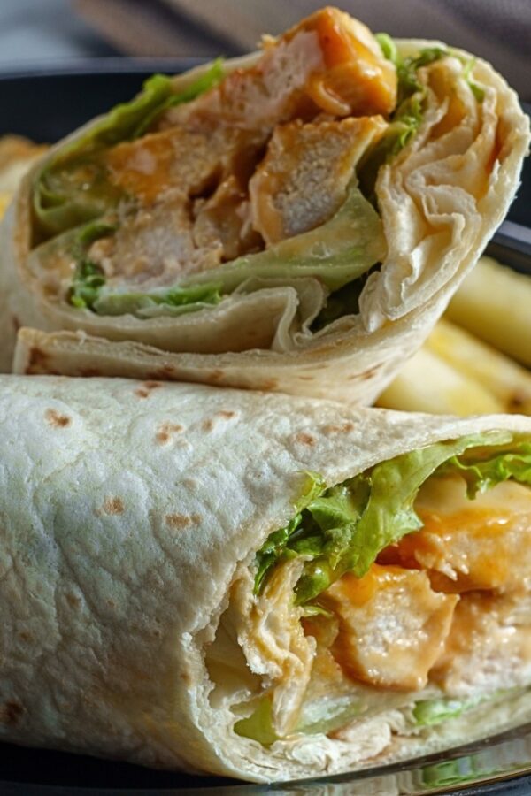 Close up image of a Buffalo Chicken Wrap cut in half