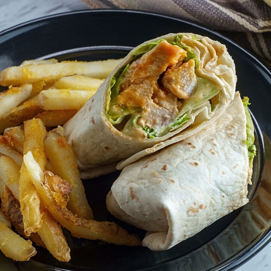 Two pieces of a buffalo chicken wrap on a low carb tortilla - 3