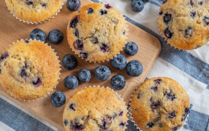 Overhead image of cottage cheese muffins with blueberries ona cutting board