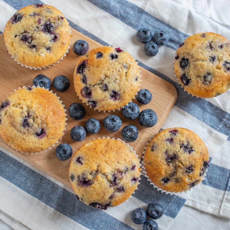 Overhead image of cottage cheese muffins with blueberries ona cutting board