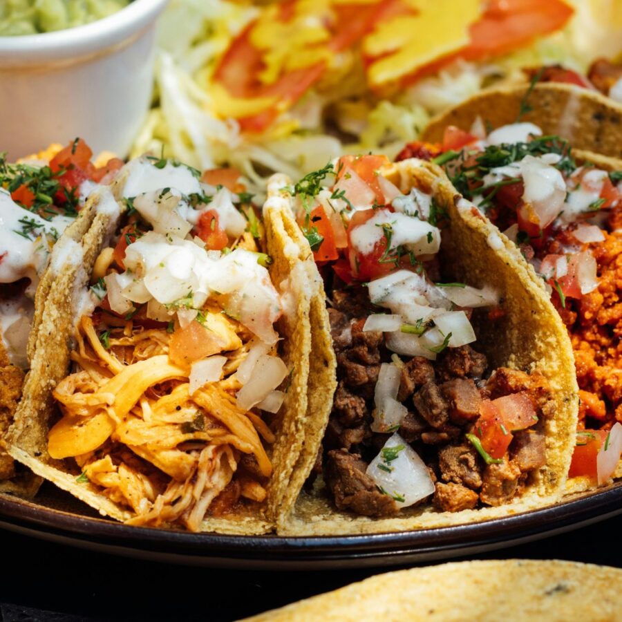 A variety of tacos on a plate made with taco bar ingredients