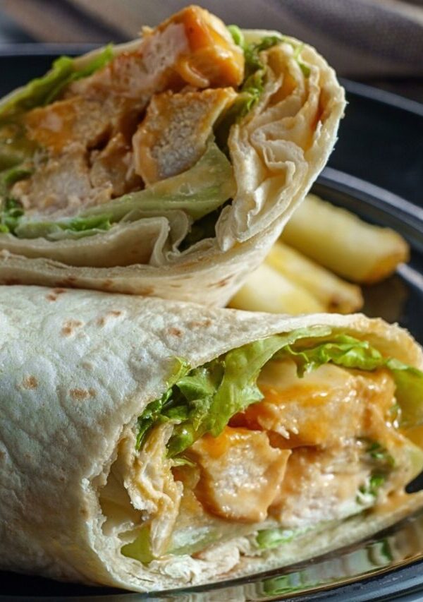 Close up image of a Buffalo Chicken Wrap cut in half