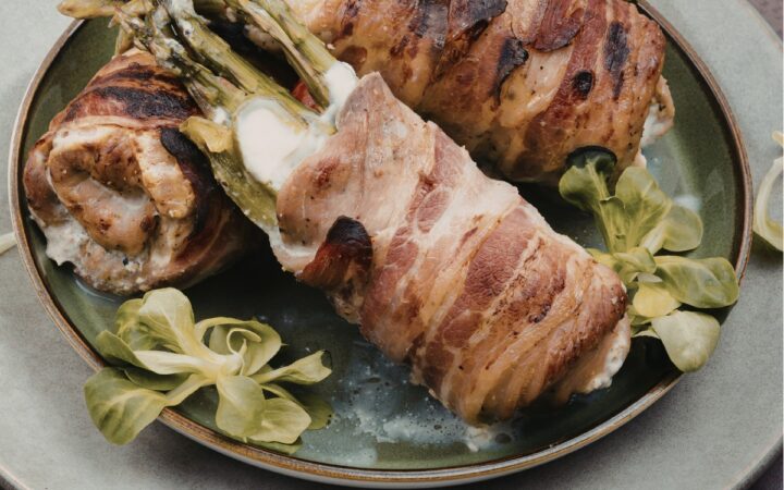 asaparagus stuffed chicken thighs on a plate