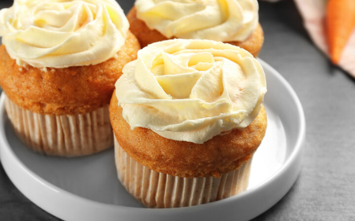 Close up image of three carrot muffins on a plate