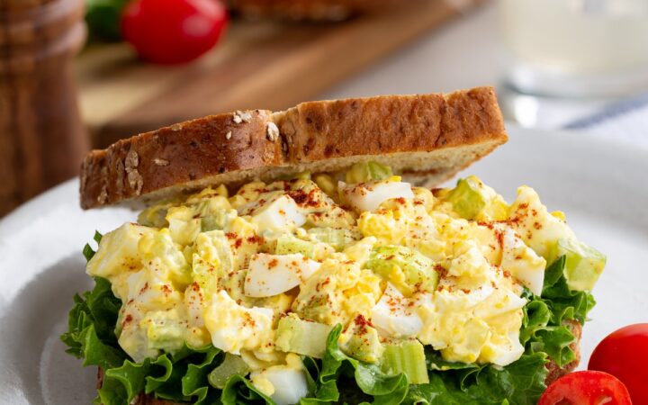 Egg Salad Sandwich on a plate with tomatoes