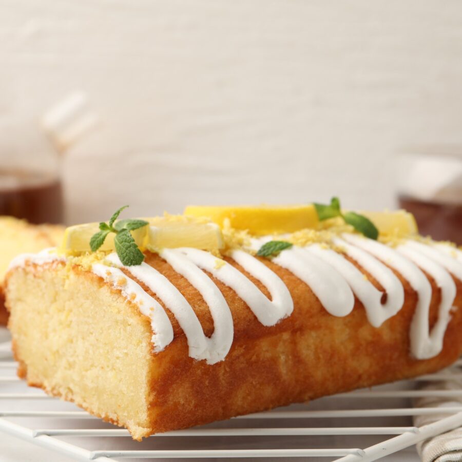 Lemon Yogurt Cake with icing drizzle and sliced lemon garnish