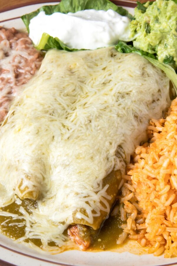 Overhead image of Turkey Enchiladas on a plate with beans and rice