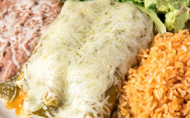 Overhead image of Turkey Enchiladas on a plate with beans and rice