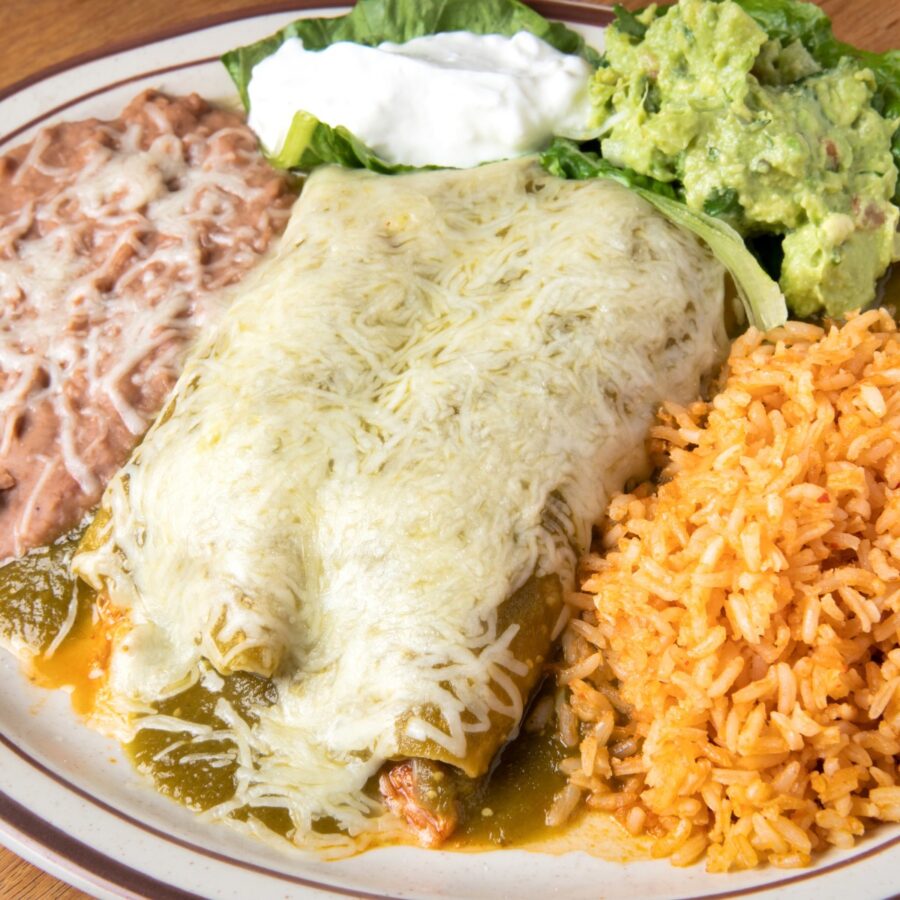 Overhead image of Turkey Enchiladas on a plate with beans and rice