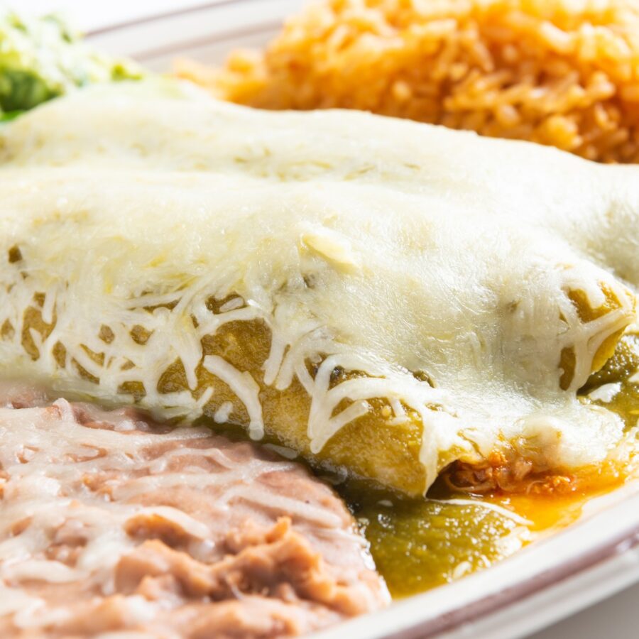Close up image of turkey enchiladas with beans and rice
