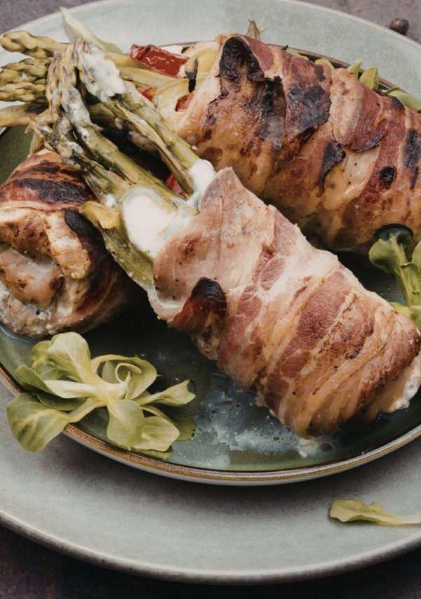 asaparagus stuffed chicken thighs on a plate