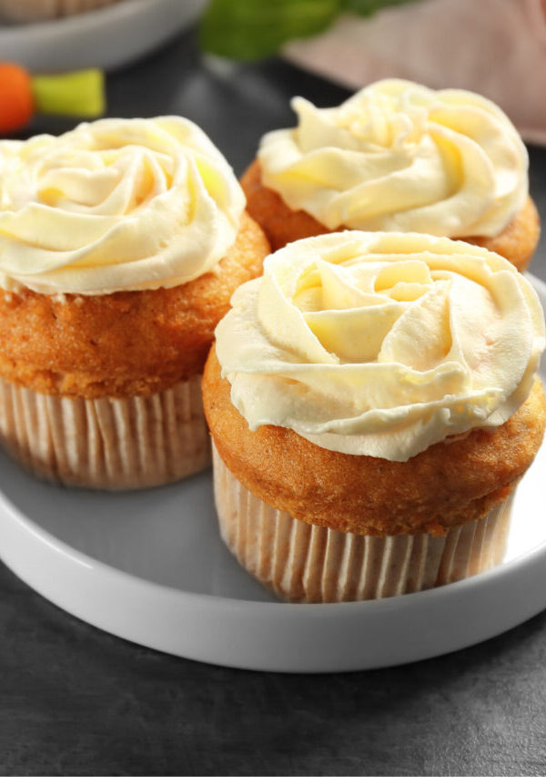 Close up image of three carrot muffins on a plate