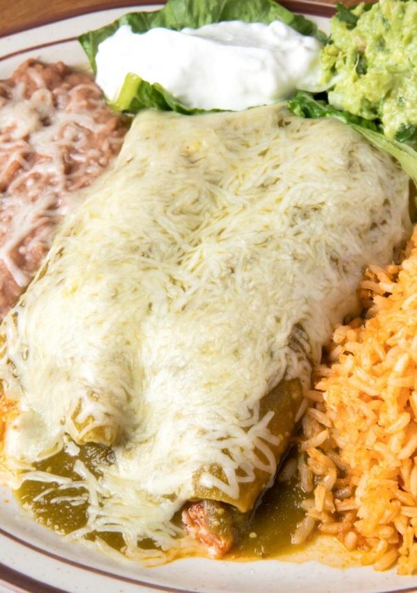 Overhead image of Turkey Enchiladas on a plate with beans and rice
