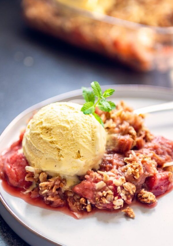 Strawberry Rhubarb Crisp on a plate with ice cream