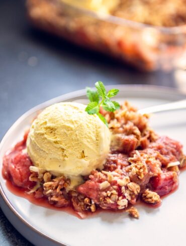 Strawberry Rhubarb Crisp on a plate with ice cream