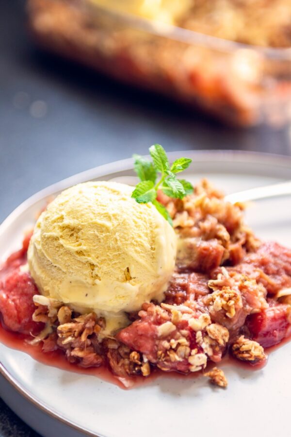 Strawberry Rhubarb Crisp on a plate with ice cream