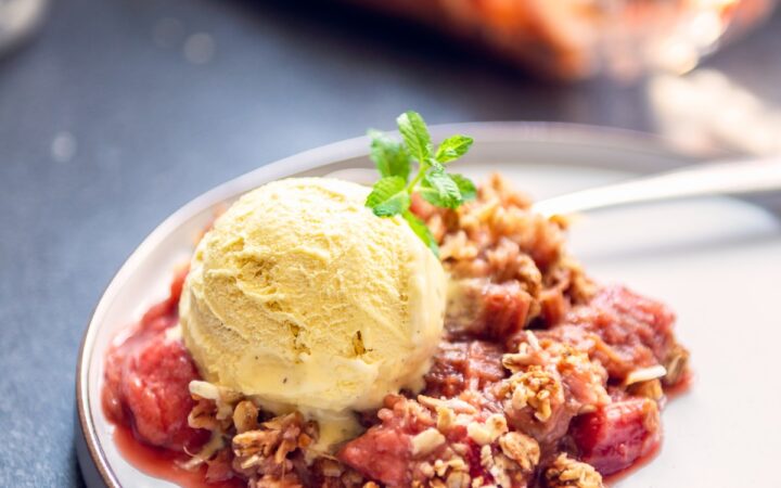 Strawberry Rhubarb Crisp on a plate with ice cream
