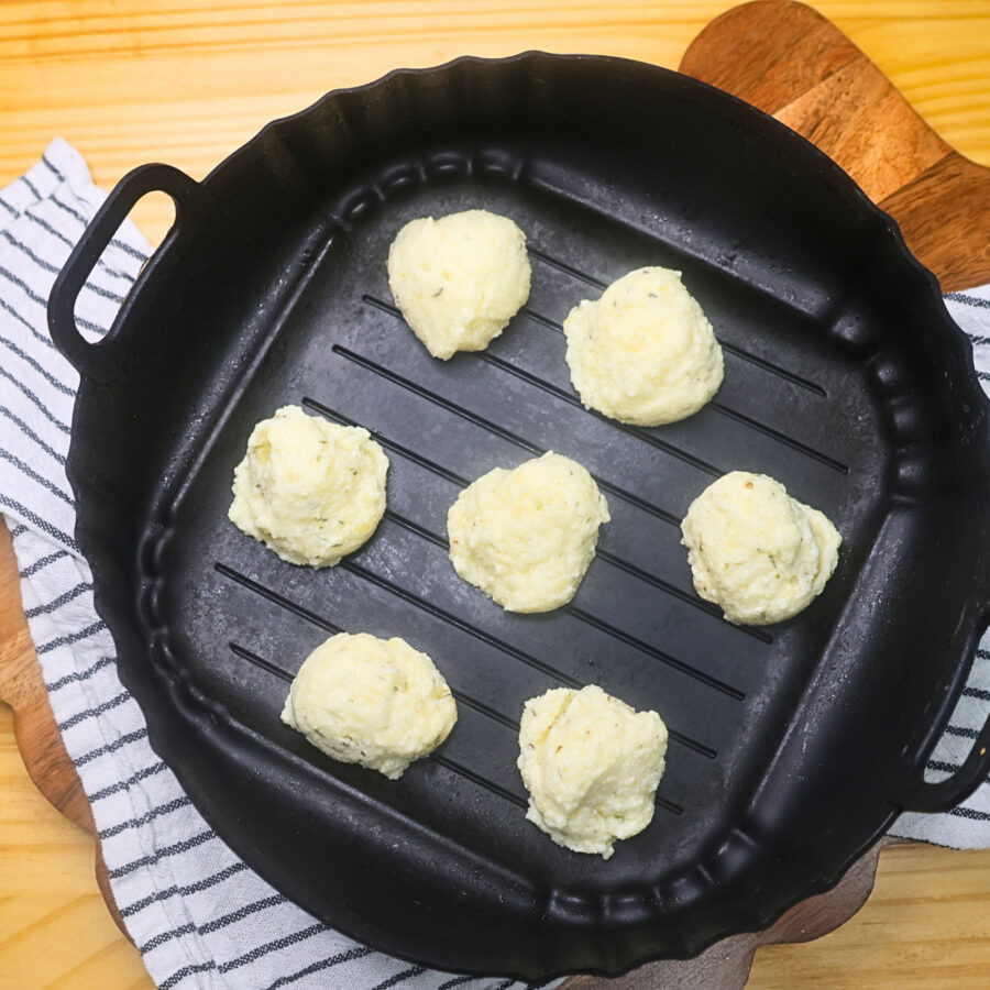 Uncooked Air Fryer Protein Cheese Bites in an air fryer basket