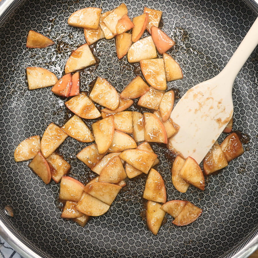 Cooked Apples in a skillet with a white spatula