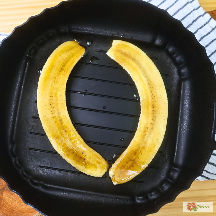 A cinnamon sugar coated banana sliced in half lenthwise in a silicone air fryer basket